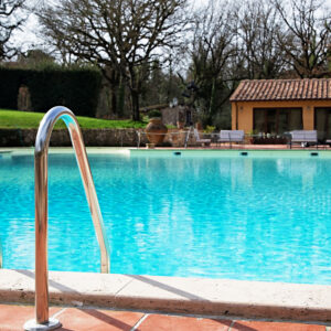 photo of Shiny chrome ladder in the pool with blue water